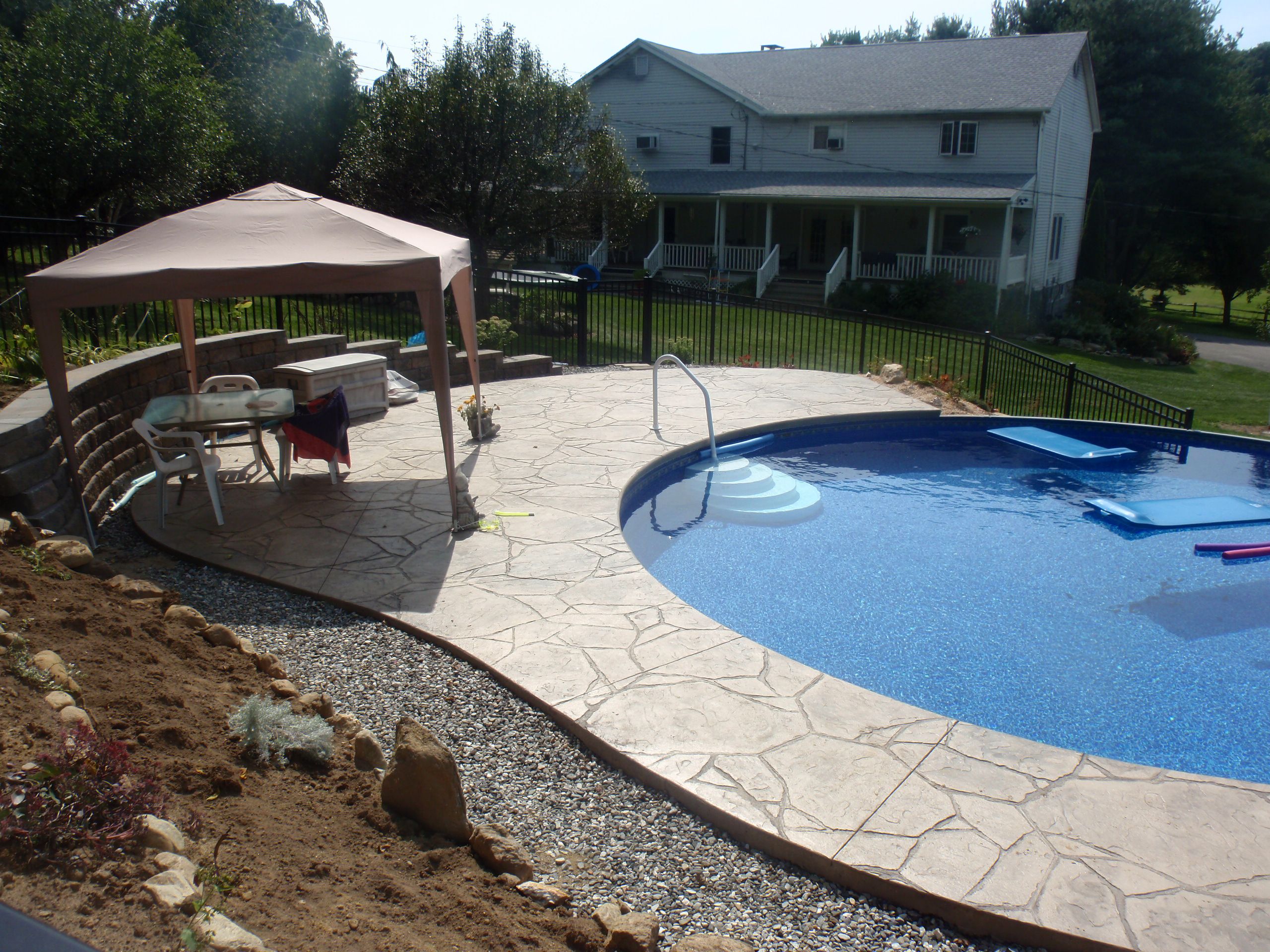 Above ground pool project with finished surrounding deck and outdoor layout